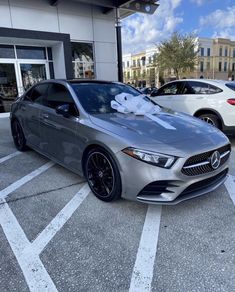 a silver car with a bow on it