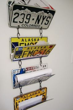 three license plates hanging on a wall