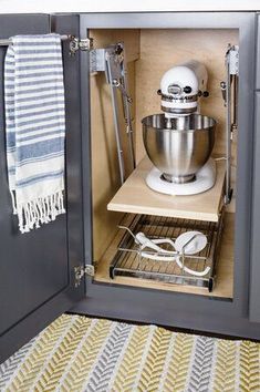 an open cabinet with a mixer and other kitchen accessories