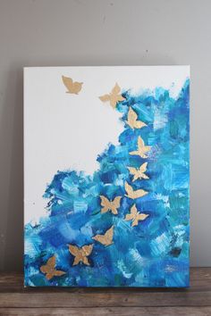 a painting with blue and gold butterflies on it