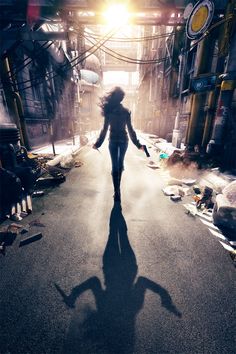 a woman walking down an alley way with her shadow on the ground and trash strewn all around