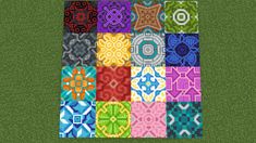 a colorful patchwork quilt with many different colors and designs on the front, along with green grass