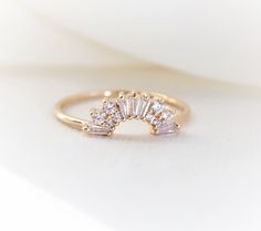 "This elegantly handmade vintage Art Deco-inspired wedding band features a glittering cluster of tapered baguettes and round stones. Before you order the band, please order a home try-on wax model here https://etsy.me/2TRvaLz There will be a 20% restocking fee deducted from your refund in case you need to return the band. So we highly recommend ordering the wax sample to see how it fits with your engagement ring. ❁❁ I T E M ∙ D E T A I L S ❁❁ ✦Stone: Conflict-Free Natural White Diamonds (SI or b Crown Band Ring, Wedding Band Above Engagement Ring, Art Deco Engagement Ring And Wedding Band, Art Deco Curved Wedding Band, Wedding Band Contour, Vintage Inspired Engagement Rings Art Deco Diamond, Gold Sparkling Rings For Wedding, Sparkling 14k Gold Wedding Jewelry, Sparkling Gold Rings For Wedding