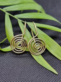 Handmade spiral coiled drop earrings. 25mm drop from lobe. Also available in sterling silver. Handmade Swirl Earrings As Gift, Handmade Swirl Earrings For Gifts, Unique Spiral Ear Wire Earrings, Spiral Earrings With Ear Wire As Gift, Spiral Earrings With Ear Wire For Gifts, Unique Swirl Earrings As Gift, Unique Swirl Earrings For Gifts, Spiral Earrings With A Modern Twist, Handmade Earrings With A Modern Twist As A Gift