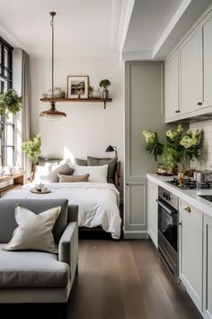 a living room filled with furniture next to a stove top oven and window covered in potted plants