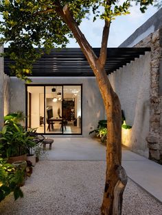 the entrance to a modern home is lit up at night