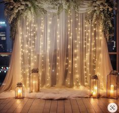 a room with lights and curtains on the windowsill is decorated with flowers, greenery and candles