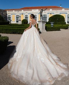 a woman in a wedding dress is standing outside