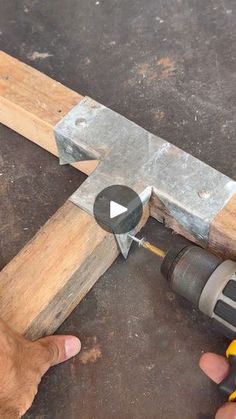 a person using a hammer to cut wood