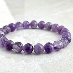 > 6mm or 8mm Chevron Amethyst > Stretchy cord; simply slide bracelet on and off wrist > Re-usable canvas pouch To ensure the perfect fit, please use the bracelet sizing instructions found in the photo gallery. Amethyst Beaded Bracelet, Shambala Bracelet, Amethyst Bracelet Beads, Stretchy Beaded Bracelet, Slide Bracelet, Chevron Amethyst, Crystal Healing Bracelets, Crystal Beads Bracelet, Bracelet Gemstone