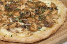 a pizza sitting on top of a wooden cutting board