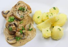 a white plate topped with potatoes and mushrooms