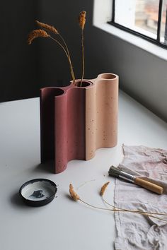 three vases sitting on top of a white table