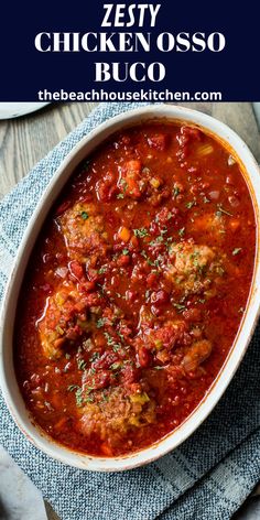 a white bowl filled with meatballs and sauce on top of a blue towel next to a