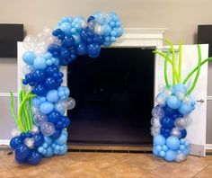 a balloon arch with blue and white balloons