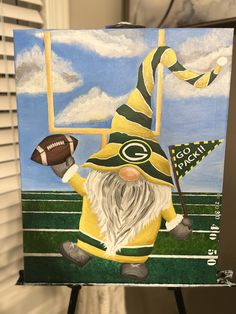 a painting of a green bay packers gnome holding a football on a field with a goalie flag