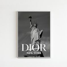 a black and white photo of the statue of liberty in new york, with the words dior above it