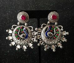 Be the envy of everyone in the room when you enter wearing these Indian CZ stylized peacock chandbali earrings. Gorgeous faux ruby, emerald and kundan set uncut faux diamonds. Beautiful peacock in all its glory, rendered in an artistic way. In a matte grey metal tone that offsets the richness of the stones. Versatile, can be worn for day or night. Really eye catching and a great conversation starter. They have a bit of a bohemian vibe. Show your wild side! find even more great earrings here: htt Stylized Peacock, Peacock Jewelry, Oxidized Silver Earrings, Afghan Jewelry, Kundan Set, Beautiful Peacock, Chandbali Earrings, Grey Metal, Indian Necklace