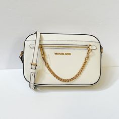 New With Tag Michael Kors Jet Set Item East West Chain Crossbody Shoulder Bag Saffiano Leather Optic White Gold Toned Hardware 100% Authentic Retail: $398.00 Plus Tax **The Pictures Look Larger Than The Bag** ***The Model Is 5'11" And Size 2*** ***Please See The Measurement For The Size*** Zip Top Closure Michael Kors Logo At Front 1 Zipper Pocket At Front Exterior Custom Fabric Lining 2 Slip-In Pockets 10" (L) X 6"(H) X 2.5"(D) Strap: 20"-23" Very Clean, Smoke-Free And Pet-Free Environment. Michael Kors Logo, Convertible Crossbody Bag, Large Crossbody Bags, Brown Crossbody Bag, Michael Kors Crossbody Bag, Brown Shoulder Bag, Black Leather Crossbody Bag, Handbag Straps, Satchel Purse