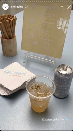 a table topped with drinks and snacks on top of a blue table cloth next to a menu