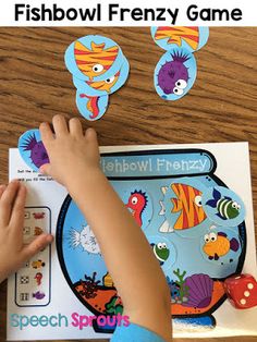 a child is playing with fishbowl frenzy game