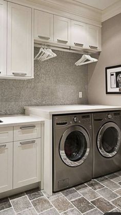 a washer and dryer sitting in a kitchen next to a counter top oven