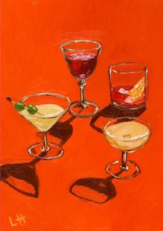 three glasses with drinks on an orange background