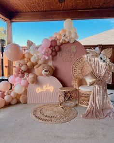 balloons and decorations are arranged on the floor for a party or celebration in pink, gold and white