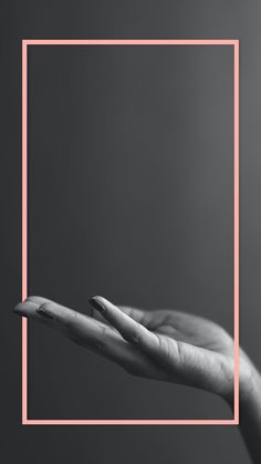 a person's hand holding out their palm in front of a square pink frame