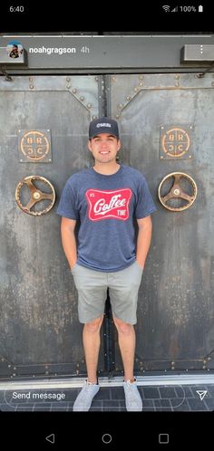 a man standing in front of a metal door