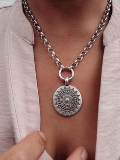 A simple but statement worthy, boho coin style pendant with an Aztec inspired sun motif. The pendant has been suspended from a medium sized link, belcher chain. Finished in an antique silver plate with a matte rather than shiny finish.  ▪️Silver plated brass belcher chain - 18 inches ▪️Pendant - 40mm x 32mm (inc bail) ▪️All parts made in Europe ▪️Presented in attractive Scraffs packaging Aztec Coin, Sun Motif, Belcher Chain, Sun Pendant, Coin Pendant Necklace, Medallion Necklace, Disc Pendant, Necklace Boho, Coin Pendant