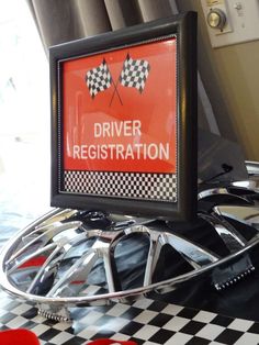 there is a sign that says driver registration on the wheel and checkered tablecloth