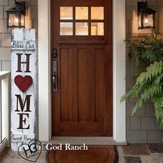 a front door with a welcome sign and potted plant next to it on the porch