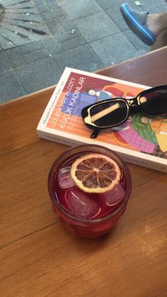 an orange slice sitting on top of a table next to a book