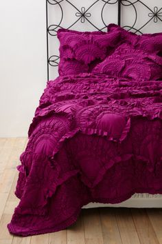 a purple bed with ruffled sheets and pillow cases on the bottom is $ 20