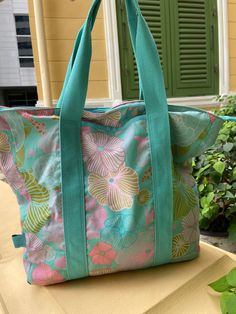 This spacious shoulder bag with zipper measures 38 x 45 x 7 cm. It is made of canvas fabric and has turquoise straps; Length 55cm. the inner lining has an inside pocket. Green Canvas Beach Bag For Travel, Green Canvas Shoulder Bag For Beach, Blue Canvas Shoulder Bag With Canvas Lining, Turquoise Tote Shoulder Bag With Adjustable Strap, Reversible Blue Shoulder Bag For Beach, Reversible Blue Shoulder Bag For The Beach, Green Rectangular Shoulder Bag With Adjustable Straps, Turquoise Summer Shoulder Bag For Everyday Use, Blue Reversible Beach Bag For Travel