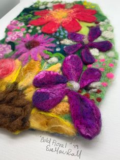 a close up of a piece of fabric with flowers on it and text that reads, felt flower bouquet