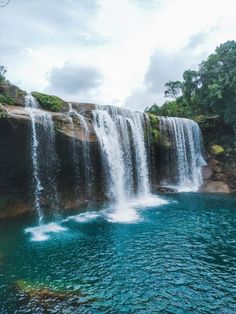 the waterfall is surrounded by blue water