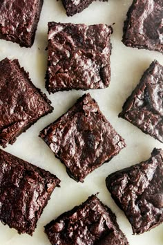 chocolate brownies sitting on top of a white surface