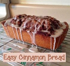 an easy cinnamon bread with icing sitting on a cooling rack