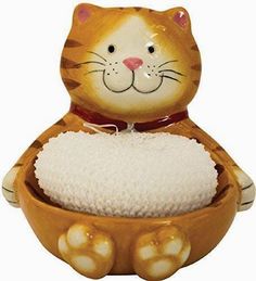 a ceramic cat sitting in a bowl filled with rice