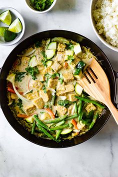 thai - style tempeh green curry in a skillet with rice and vegetables