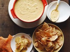 chips, dip and tortilla are on plates next to bowls with dipping sauce