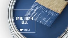 a blue paint can with the words dark cobaltt blue on it and a brush