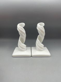 two white vases sitting on top of each other