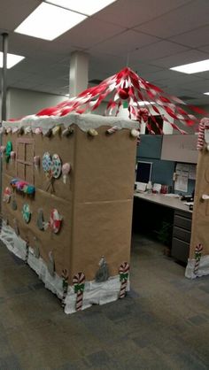 an office cubicle decorated for christmas with candy canes and decorations on the walls