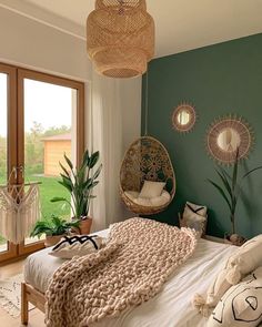 a bedroom with green walls and white bedding, hanging planters on the wall