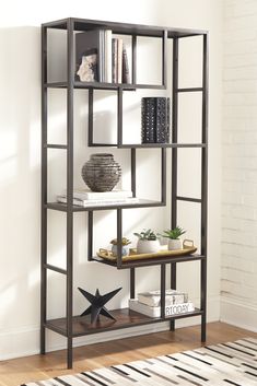 a book shelf with books and plants on it