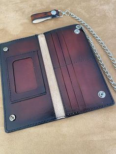 a leather wallet with chain attached to it