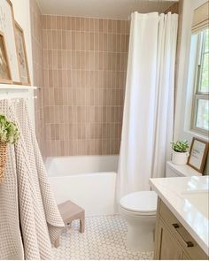 a bathroom with a toilet, sink and bathtub